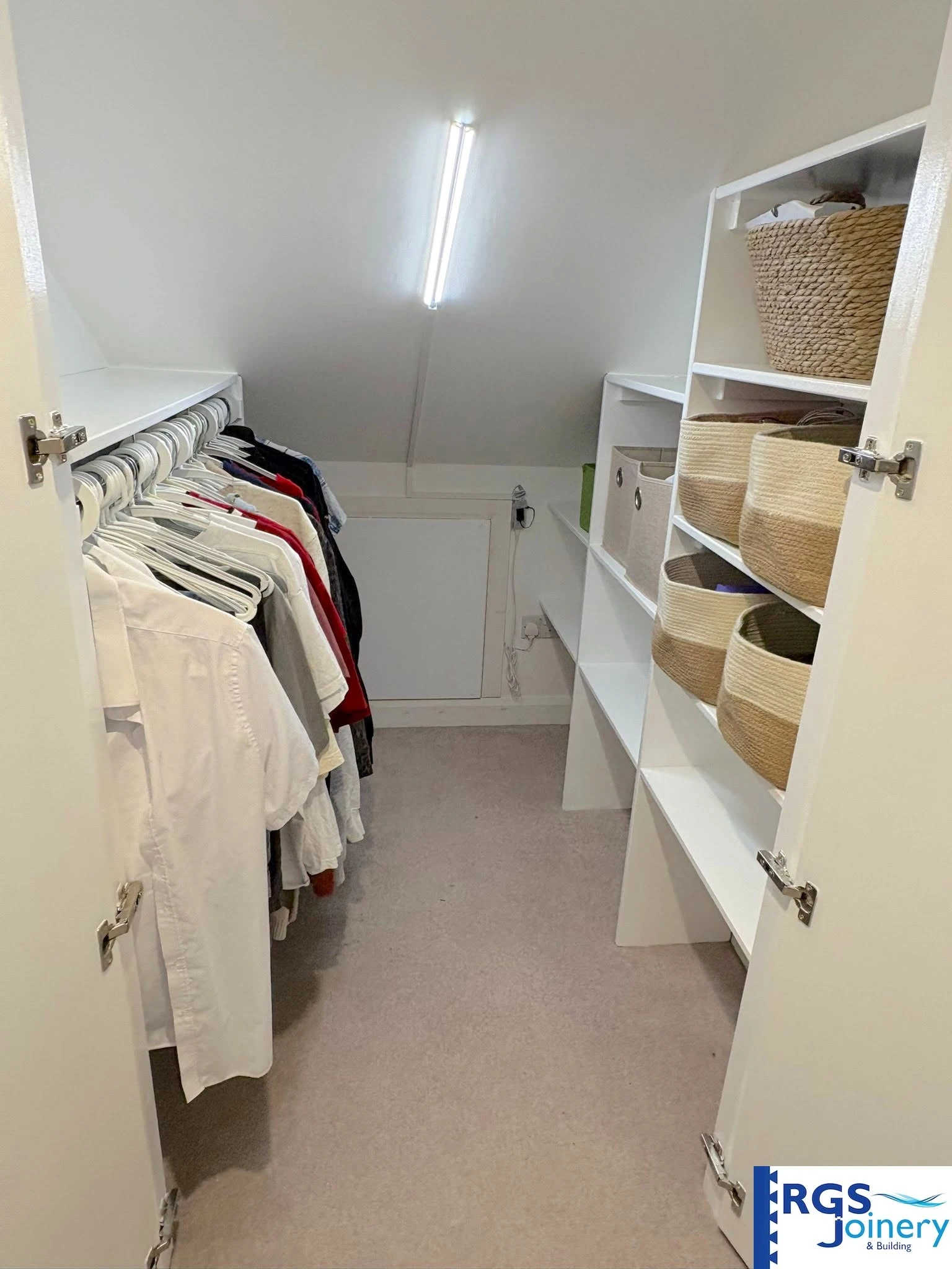 Loft walk-in wardrobe finished in high-gloss white, built by RGS Joinery and Building