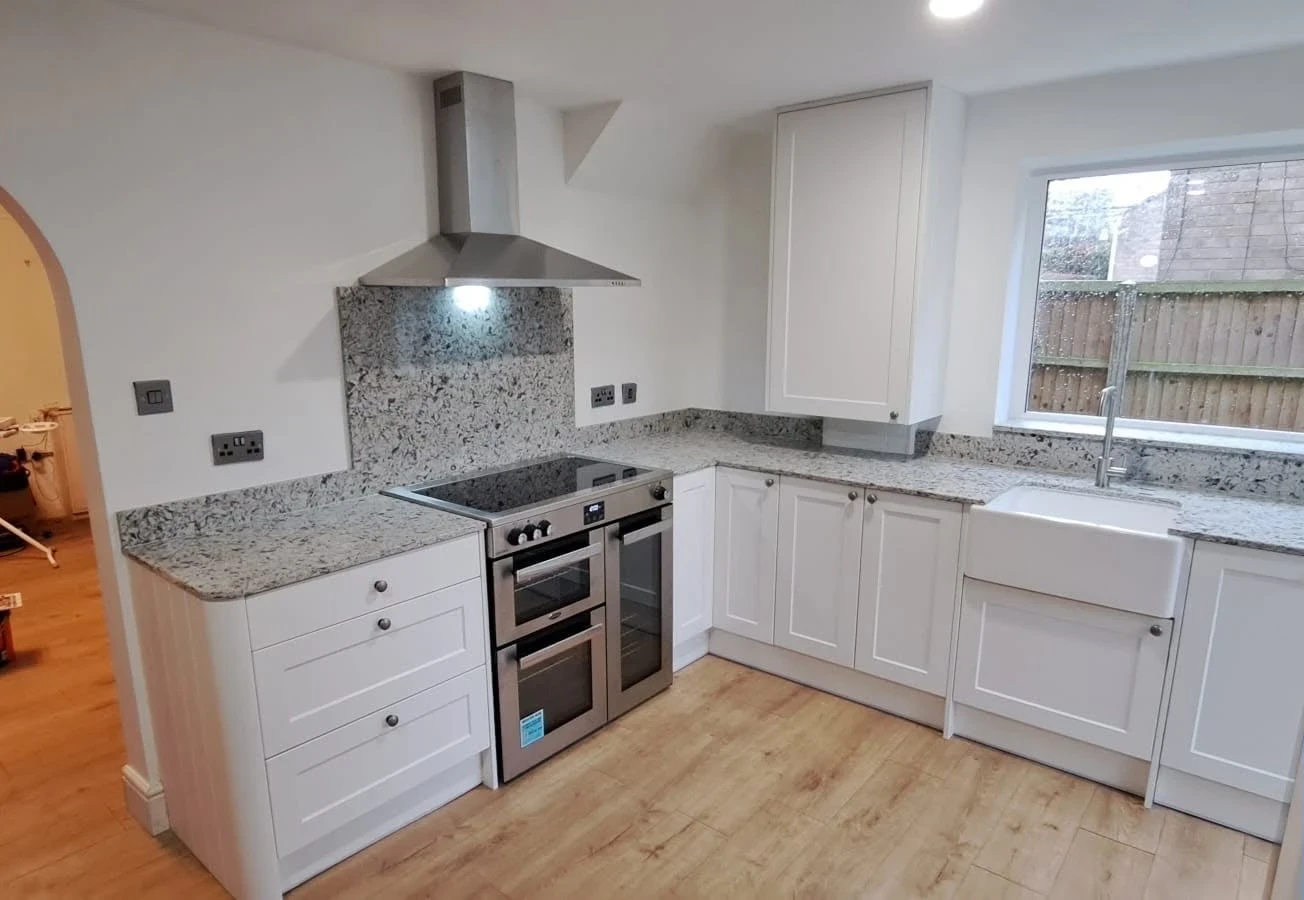 White shaker kitchen with granite worktops and Belfast sink, fitted by RGS Joinery and Building